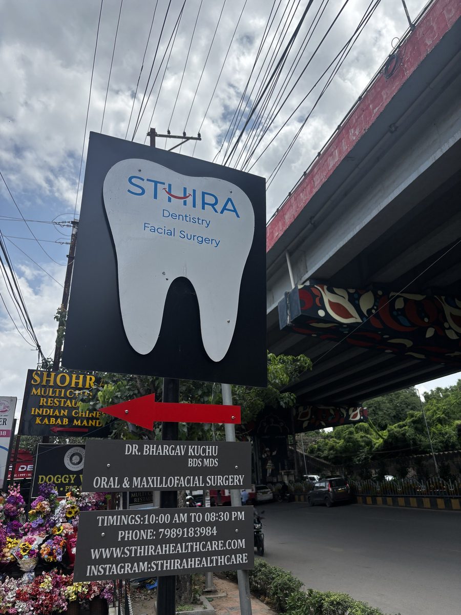 STHIRA Dentistry and Facial Surgery signboard on the road at Raidurg